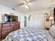 Bedroom with a television on a dresser and a view into the entryway and closet at 3142 Crenshaw Ct, New Port Richey, FL 34655