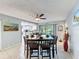 Dining room featuring stylish table and chairs, leading to the kitchen with stainless appliances at 3142 Crenshaw Ct, New Port Richey, FL 34655