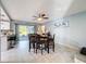 Open dining room area showcasing a modern table, chandelier, and a sliding door to the lanai at 3142 Crenshaw Ct, New Port Richey, FL 34655