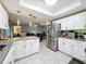 Well-lit kitchen with white cabinetry, stainless steel appliances, and granite countertops at 3142 Crenshaw Ct, New Port Richey, FL 34655