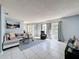 Inviting living room with a cozy seating arrangement, large windows, and ample natural light at 3142 Crenshaw Ct, New Port Richey, FL 34655