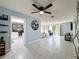 Bright living area with a ceiling fan, views to dining area, and decorative tree accent at 3142 Crenshaw Ct, New Port Richey, FL 34655