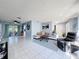 Open concept living room with tile floors, neutral color scheme, and comfortable seating area at 3142 Crenshaw Ct, New Port Richey, FL 34655