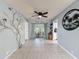 Spacious room with sliding doors to patio, decorative tree accent and decorative wall art at 3142 Crenshaw Ct, New Port Richey, FL 34655