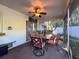 The screened patio includes a ceiling fan and an outdoor table with cushioned seating, perfect for relaxing outdoors at 3142 Crenshaw Ct, New Port Richey, FL 34655