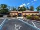 Secured and gated pool entrance flanked by covered porticos and professional landscaping with accessible parking at 3142 Crenshaw Ct, New Port Richey, FL 34655