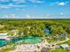 Aerial view of a water park with slides, swimming areas, and lush greenery on a sunny day at 3215 Hibiscus Dr, Hernando Beach, FL 34607