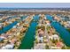 High aerial view of a waterfront community on a sunny day, showcasing waterfront access and boating canals at 3215 Hibiscus Dr, Hernando Beach, FL 34607