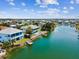 Aerial view of waterfront homes along a canal with boat docks and lush vegetation at 3215 Hibiscus Dr, Hernando Beach, FL 34607