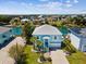 Aerial view of the waterfront home with a well-manicured lawn and canal views at 3215 Hibiscus Dr, Hernando Beach, FL 34607