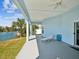 Back porch with waterfront views, a lounge chair and room for entertaining at 3215 Hibiscus Dr, Hernando Beach, FL 34607