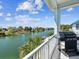 Balcony with a grill overlooking a canal with waterfront views on a sunny day at 3215 Hibiscus Dr, Hernando Beach, FL 34607