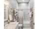 Well-lit bathroom featuring stylish white tile, modern fixtures, and elegant decor at 3215 Hibiscus Dr, Hernando Beach, FL 34607