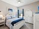 Bright bedroom featuring neutral paint, white furniture, and a comfortable bed with stylish patterned bedding at 3215 Hibiscus Dr, Hernando Beach, FL 34607