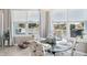 Dining area with views has a glass table, chandelier, and chairs at 3215 Hibiscus Dr, Hernando Beach, FL 34607