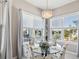 Bright dining area with water views, chandelier, and seating at 3215 Hibiscus Dr, Hernando Beach, FL 34607