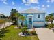 Charming two-story home with a well-manicured lawn, palm trees and an attached garage in a suburban setting at 3215 Hibiscus Dr, Hernando Beach, FL 34607