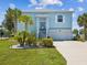 Charming two-story home with a well-manicured lawn, palm trees and an attached garage in a suburban setting at 3215 Hibiscus Dr, Hernando Beach, FL 34607