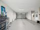 Spacious garage with painted concrete floor, garage door, and utility storage at 3215 Hibiscus Dr, Hernando Beach, FL 34607
