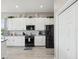 White kitchen with black appliances and modern finishes and decor at 3215 Hibiscus Dr, Hernando Beach, FL 34607
