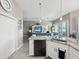 Open concept kitchen boasts a granite island, white cabinets, and stainless steel appliances at 3215 Hibiscus Dr, Hernando Beach, FL 34607