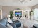 Comfortable living room with a large television, built-in shelves, and an open floor plan at 3215 Hibiscus Dr, Hernando Beach, FL 34607