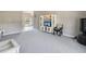 Open living room with television, white entertainment center and backyard views at 3215 Hibiscus Dr, Hernando Beach, FL 34607