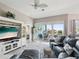 Spacious living room with a ceiling fan, large windows, and water views at 3215 Hibiscus Dr, Hernando Beach, FL 34607