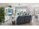 Bright living room with access to the porch, a large sofa, and stylish decor at 3215 Hibiscus Dr, Hernando Beach, FL 34607