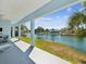Covered porch view of the serene canal and waterfront landscape at 3215 Hibiscus Dr, Hernando Beach, FL 34607