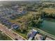 Aerial view capturing the neighborhood's proximity to lush greenery and waterfront, showing community living at 36419 Flats St, Zephyrhills, FL 33541