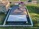 Aerial view of a home with a fenced backyard, patio, and well-manicured lawn at 36419 Flats St, Zephyrhills, FL 33541