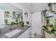 Well-decorated bathroom with a granite countertop, framed mirror, and bathtub-shower combination at 36419 Flats St, Zephyrhills, FL 33541