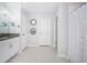 Bathroom featuring white vanity with granite countertop, decorative mirrors and a shower at 36419 Flats St, Zephyrhills, FL 33541