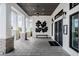 Elegant entrance showcasing white columns, stone accents, and a black double door with decorative wall art at 36419 Flats St, Zephyrhills, FL 33541