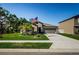 Charming single-story home features a well-manicured lawn and a two-car garage at 36419 Flats St, Zephyrhills, FL 33541