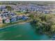Aerial view showcasing a peaceful lake surrounded by trees and houses in a residential area at 36419 Flats St, Zephyrhills, FL 33541