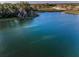 A tranquil lake surrounded by lush trees and nearby homes at 36419 Flats St, Zephyrhills, FL 33541