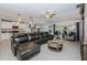 Spacious living room featuring an open floor plan, a leather sectional sofa, and modern decor at 36419 Flats St, Zephyrhills, FL 33541