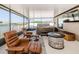 Relaxing screened patio features comfortable seating, a hot tub, a fire pit, and a beautiful lake view at 36419 Flats St, Zephyrhills, FL 33541