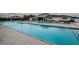 A stunning zero entry community pool with ample lounge seating and a beautiful clubhouse at 36419 Flats St, Zephyrhills, FL 33541
