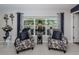 Comfortable sitting area with patterned armchairs, a window overlooking the backyard, and accent decor at 36419 Flats St, Zephyrhills, FL 33541