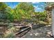 A terraced backyard with a variety of plantings and a concrete patio at 3741 Appleton Ct, Palm Harbor, FL 34684