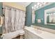 Well-lit bathroom features a shower-tub combination and a vanity with a mirror at 3741 Appleton Ct, Palm Harbor, FL 34684