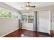 Bedroom featuring wood floors, a ceiling fan, and views to the screened lanai at 3741 Appleton Ct, Palm Harbor, FL 34684