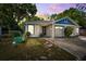 Charming single-story home with a single-car garage, complemented by a serene sunset backdrop at 3741 Appleton Ct, Palm Harbor, FL 34684