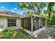 Home exterior showcasing the screened-in lanai and lush backyard at 3741 Appleton Ct, Palm Harbor, FL 34684