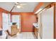 A cozy kitchen featuring wood cabinets, white appliances, tile floors, and a bright window at 3741 Appleton Ct, Palm Harbor, FL 34684