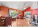 Bright living room featuring hardwood floors, a large window, and a comfortable leather sofa at 3741 Appleton Ct, Palm Harbor, FL 34684