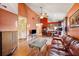 Cozy living room with hardwood floors, a vaulted ceiling, and access to the kitchen at 3741 Appleton Ct, Palm Harbor, FL 34684